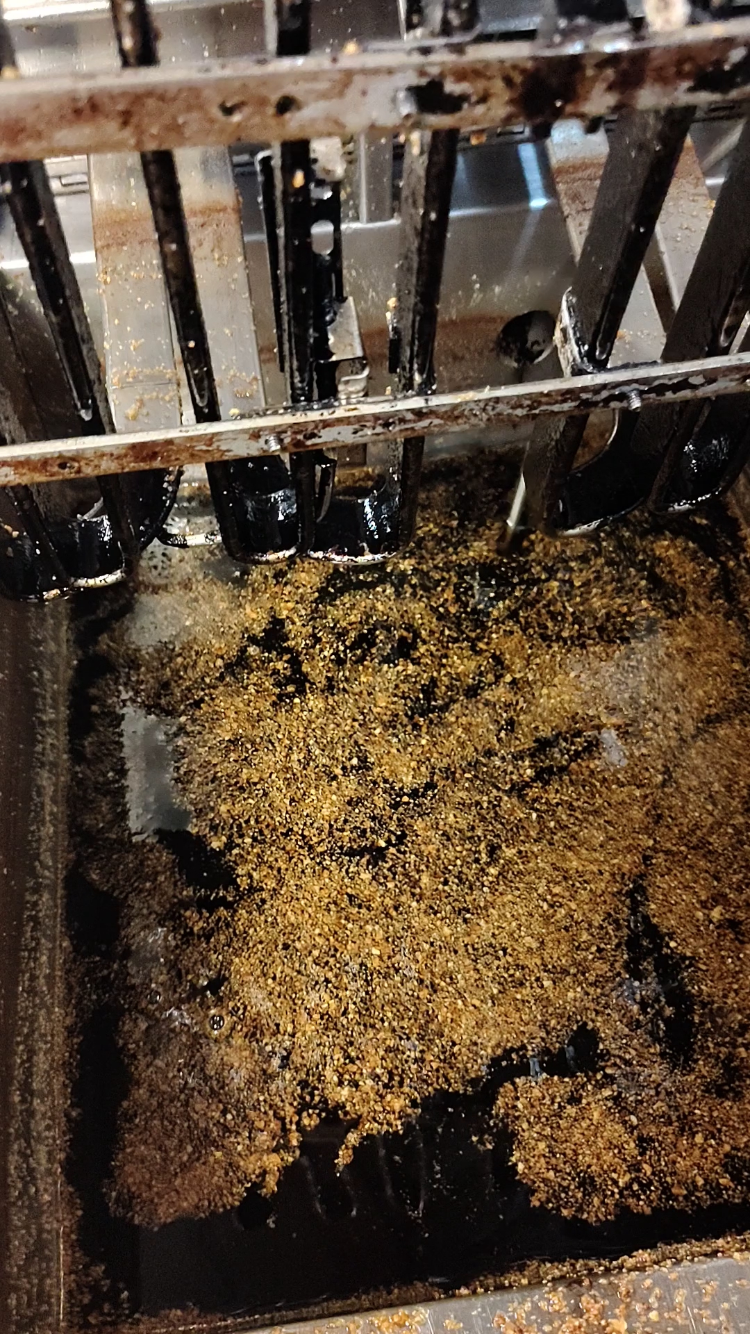 Before cleaning: grease and buildup inside the fryer.